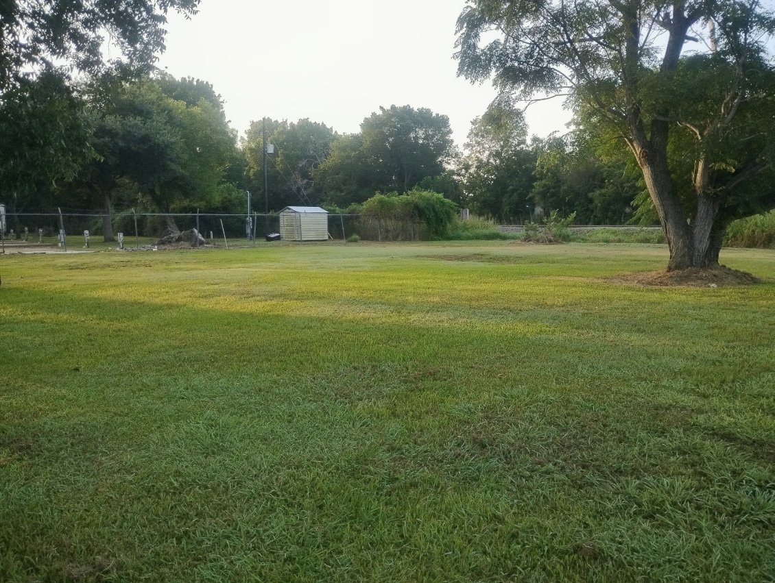Open green space at Traveler's Paradise RV Park in Bay City, TX, planned for a dog park