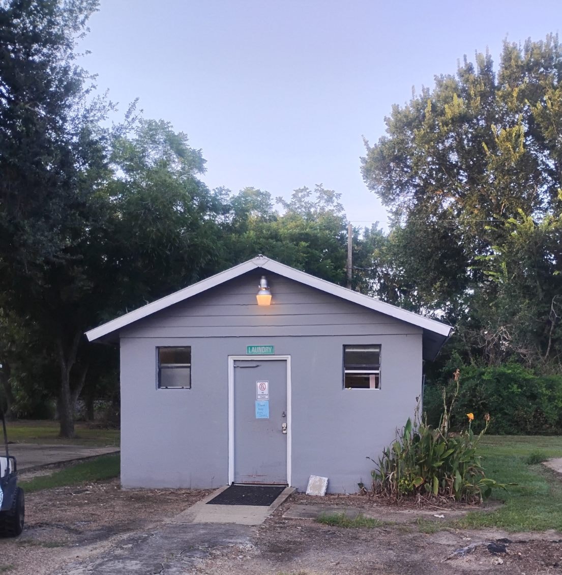 Exterior of the on-site laundry building at Traveler's Paradise RV Park in Bay City, TX