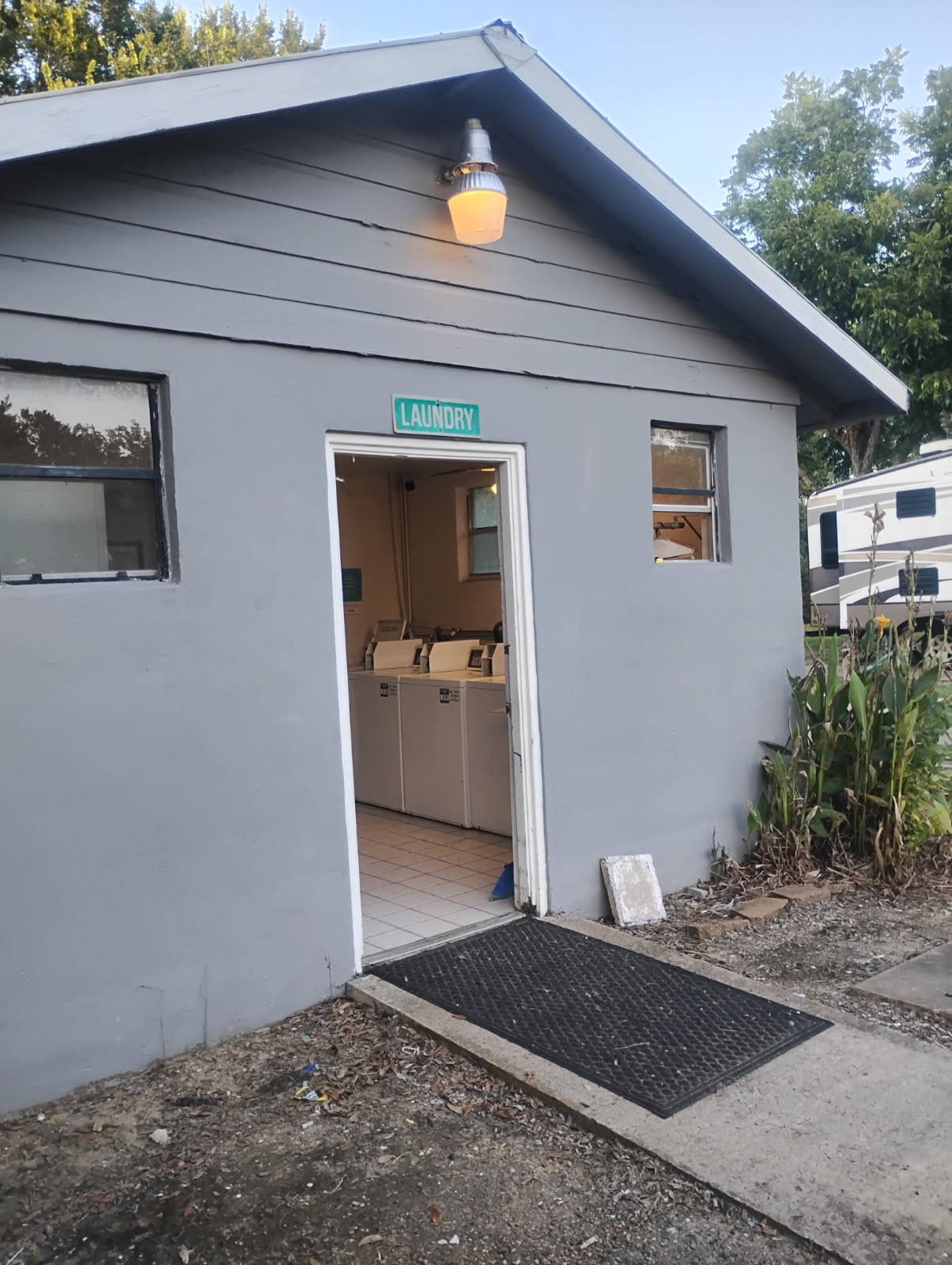 Exterior entrance to the on-site laundry building at Traveler's Paradise RV Park in Bay City, TX