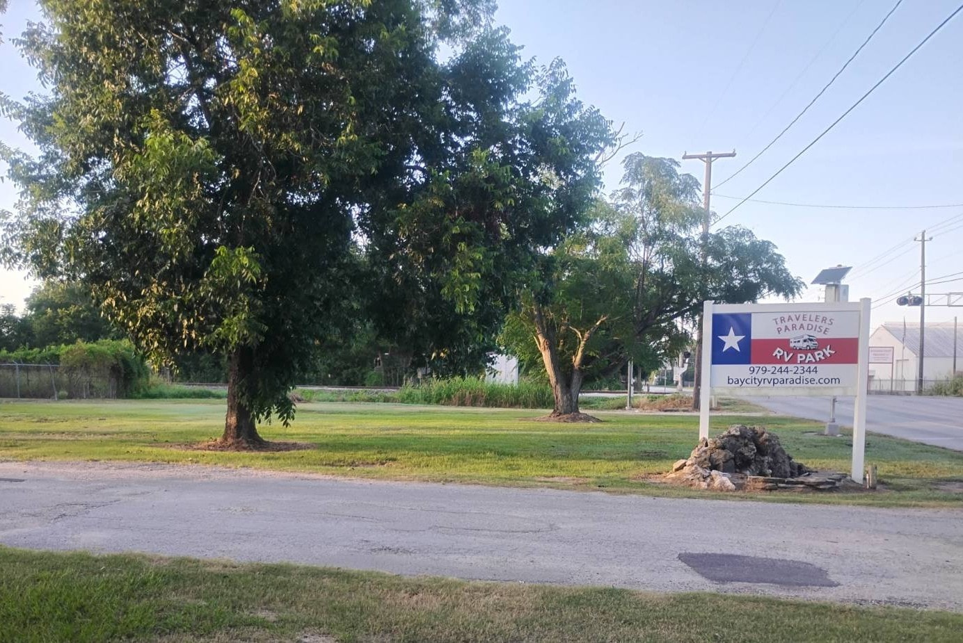 Traveler's Paradise RV Park gated entrance sign on Nichols Ave in Bay City, TX