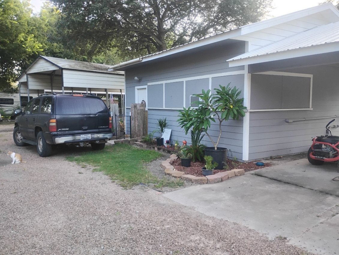 Furnished studio rental exterior with dedicated parking at Traveler's Paradise RV Park in Bay City, TX