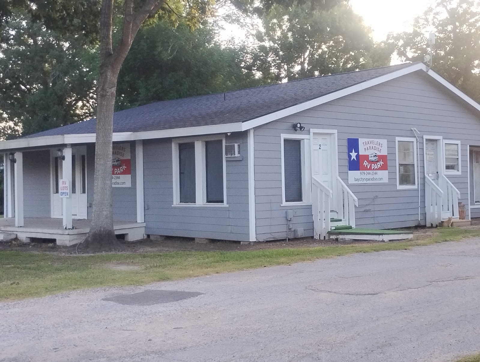 Park grounds with trucks and RVs at Traveler's Paradise RV Park