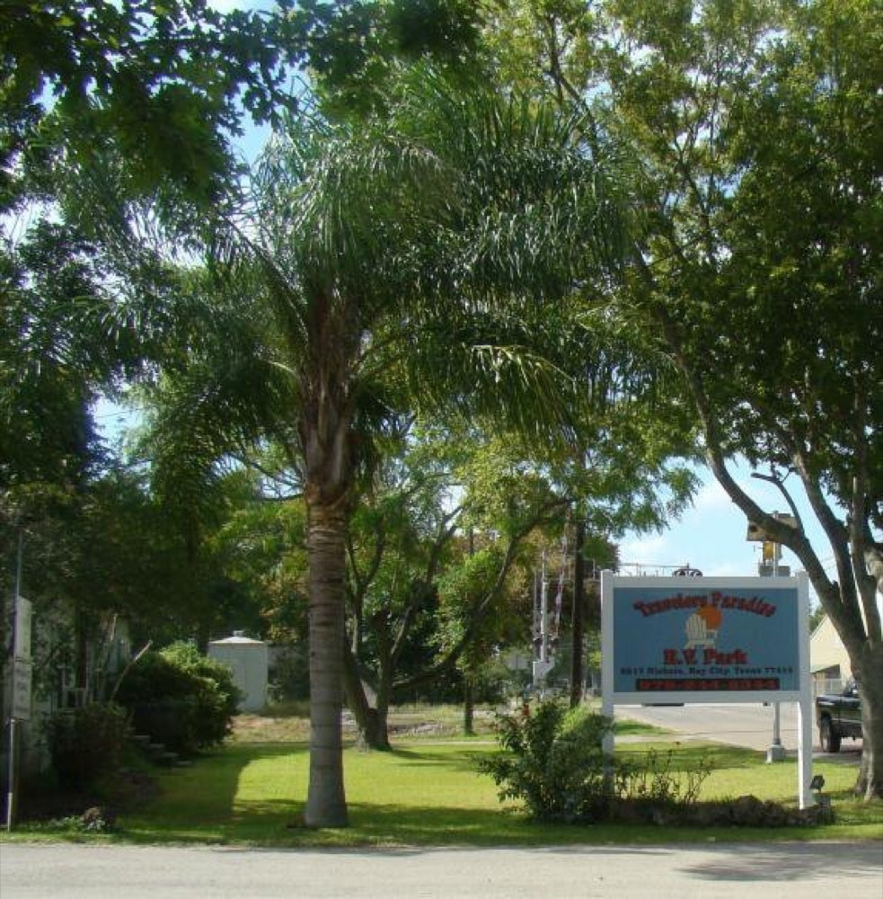 Park grounds and signage at Traveler's Paradise RV Park